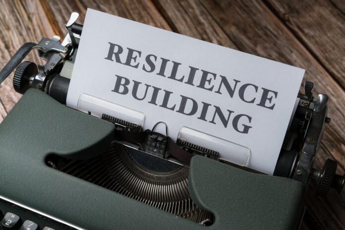 pexels-photo-18536266 a typewriter with the word resilience building on it